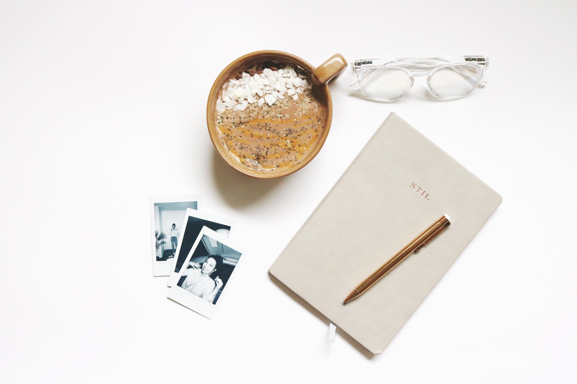 Brown Ceramic Cup Beside Notebook and Pen